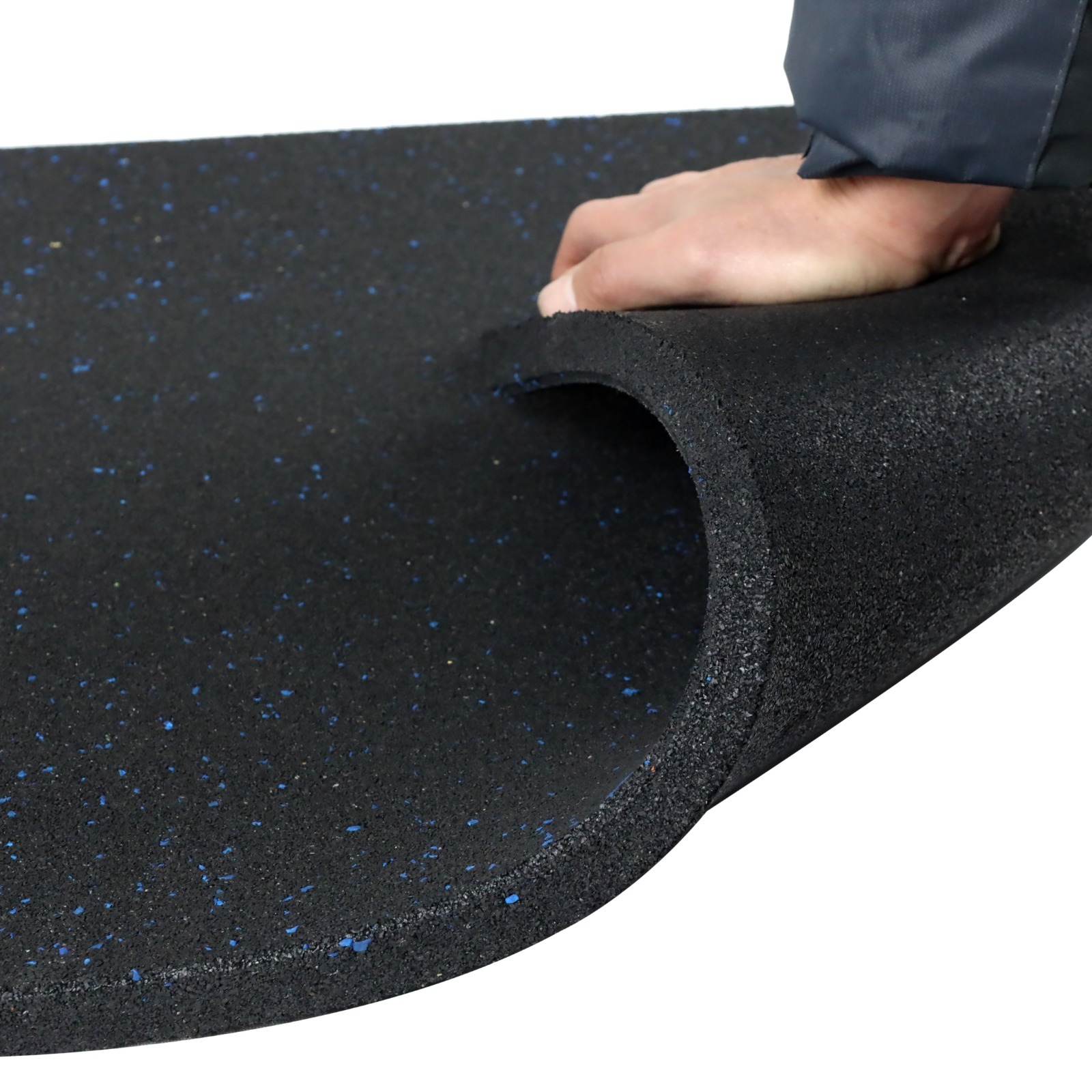 Black and blue fleck rubber flooring bent to show flexibility