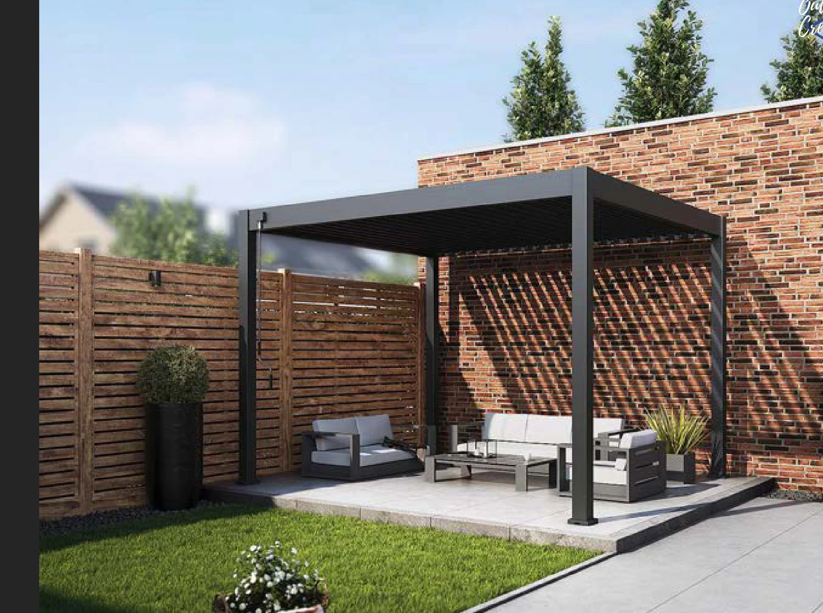VARDHUS STEEL freestanding dark pergola beside a brick garden wall