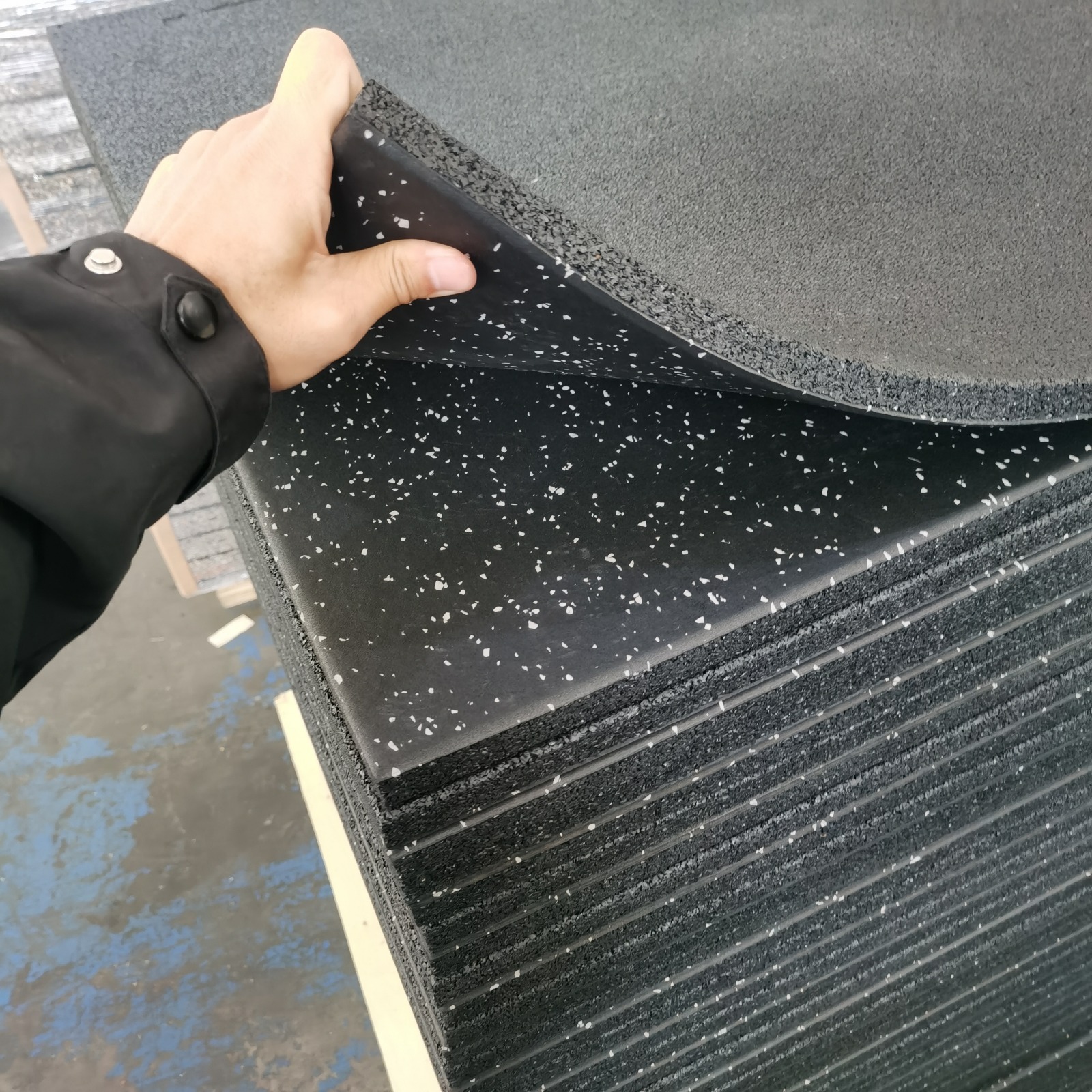 Flexible layered impact rubber gym flooring with speckled wear surface
