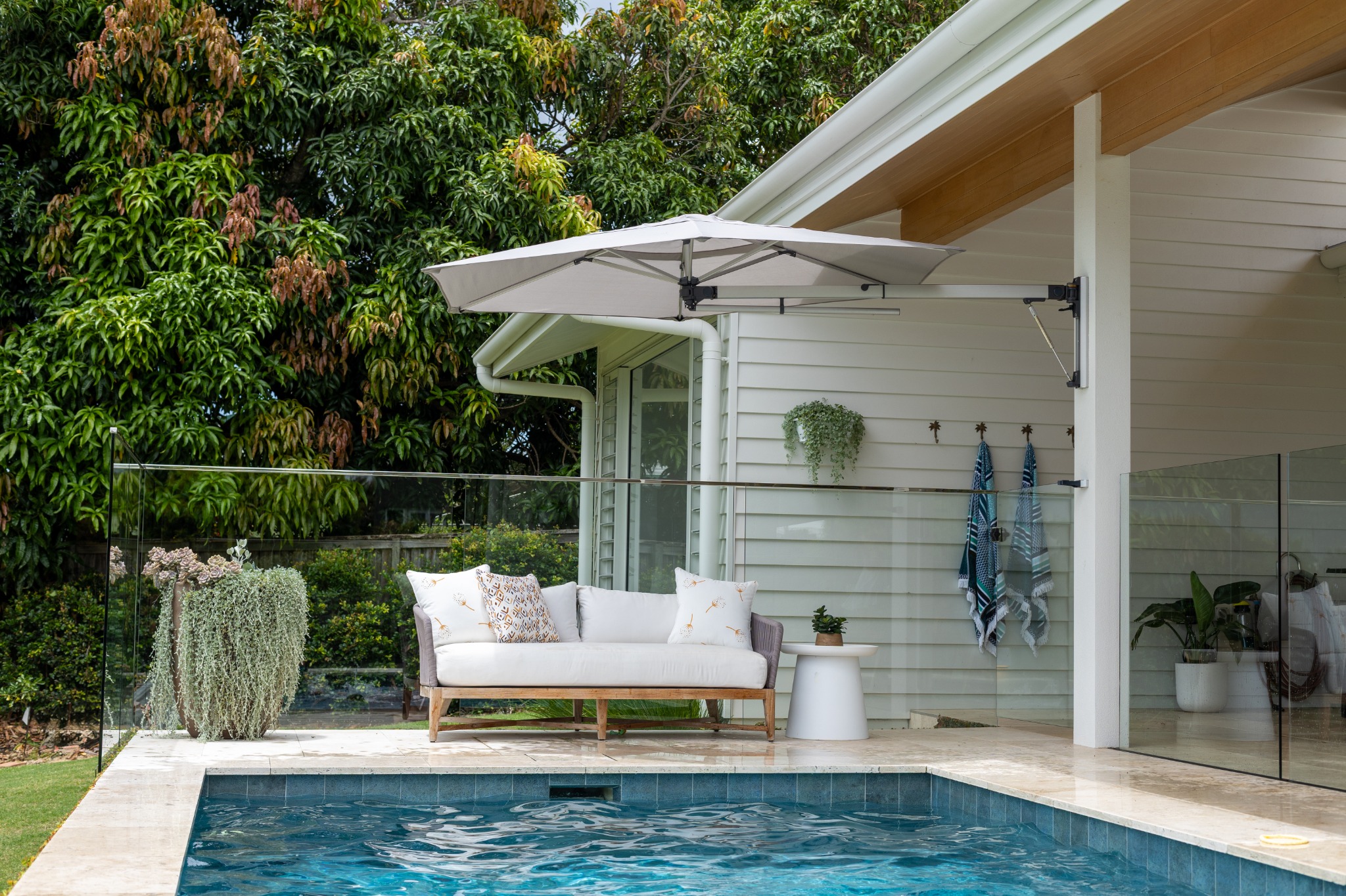 Shadowspec RETREAT wall-mounted umbrella shading a compact residential terrace