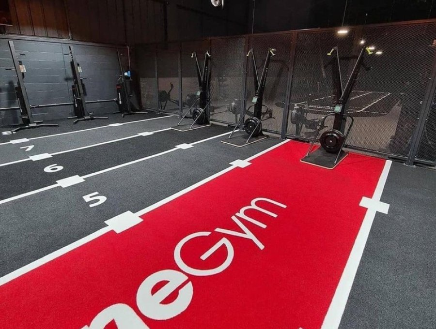 Functional fitness gym with black and red numbered training lanes