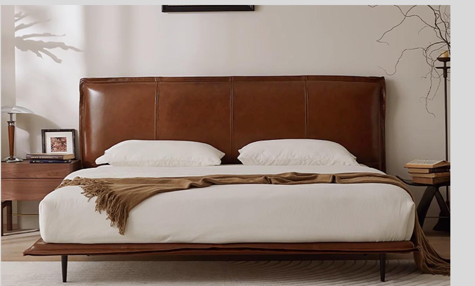 SKELVAR cognac upholstered Mid-Century platform bed with slim dark legs