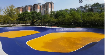 Curved roller-sport track in a landscaped recreation area