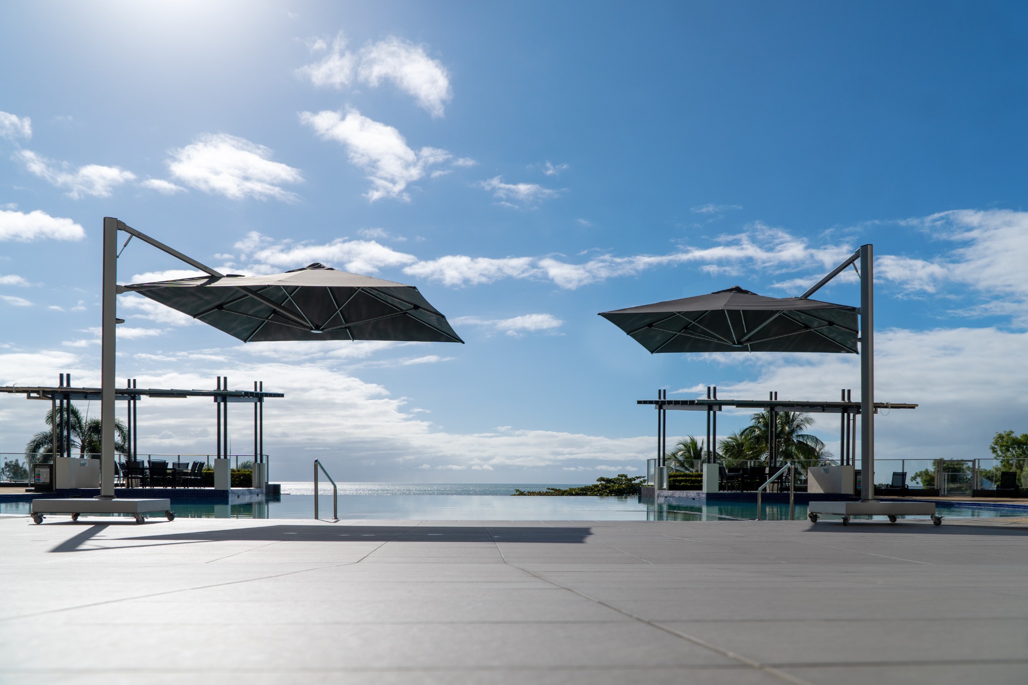 Shadowspec SERENITY rotating cantilever umbrella in a landscaped New Zealand setting