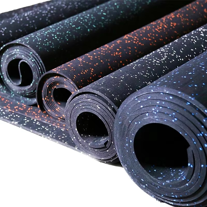 Multiple rubber floor rolls with blue green orange and white flecks