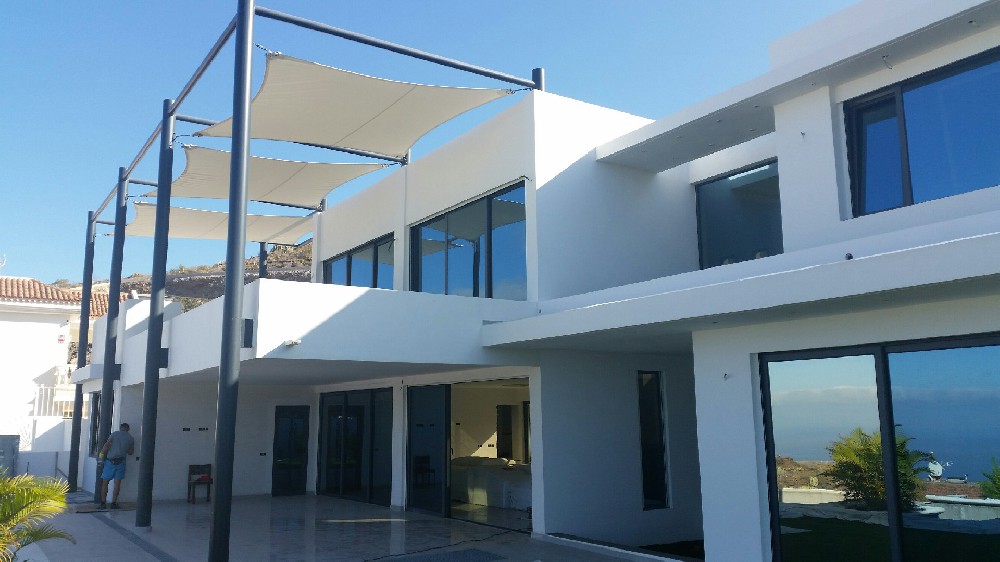 Coastal Canary Islands building with dark aluminium windows and sliding doors